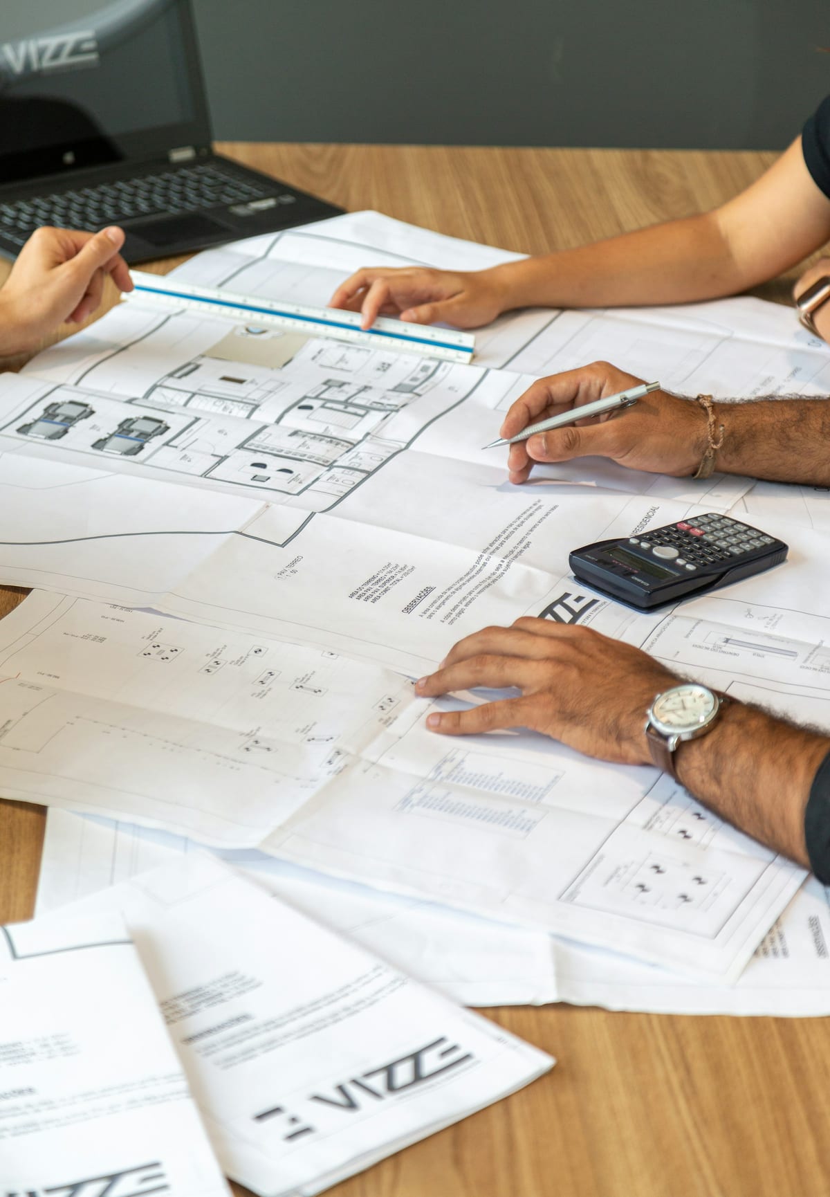 Team reviewing architectural drawings on a large desk